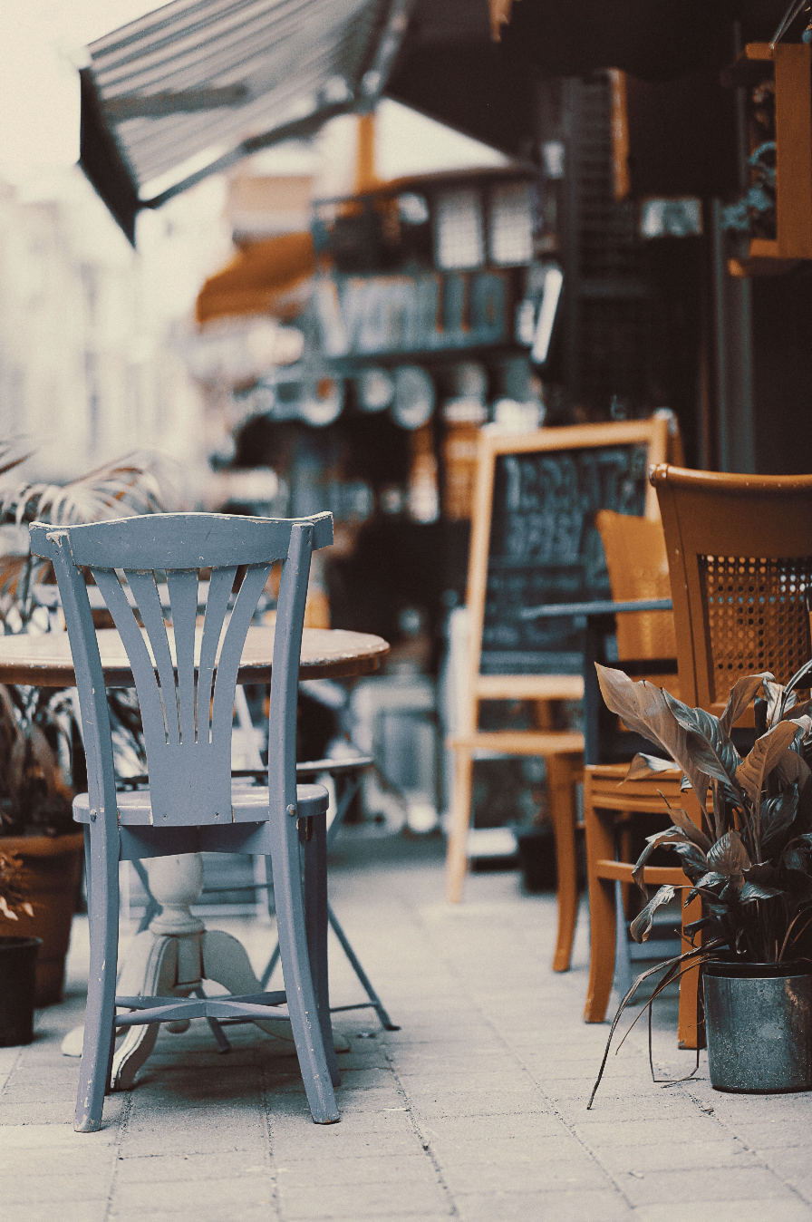 Sidewalk cafe seating outside a neighborhood coffee shop